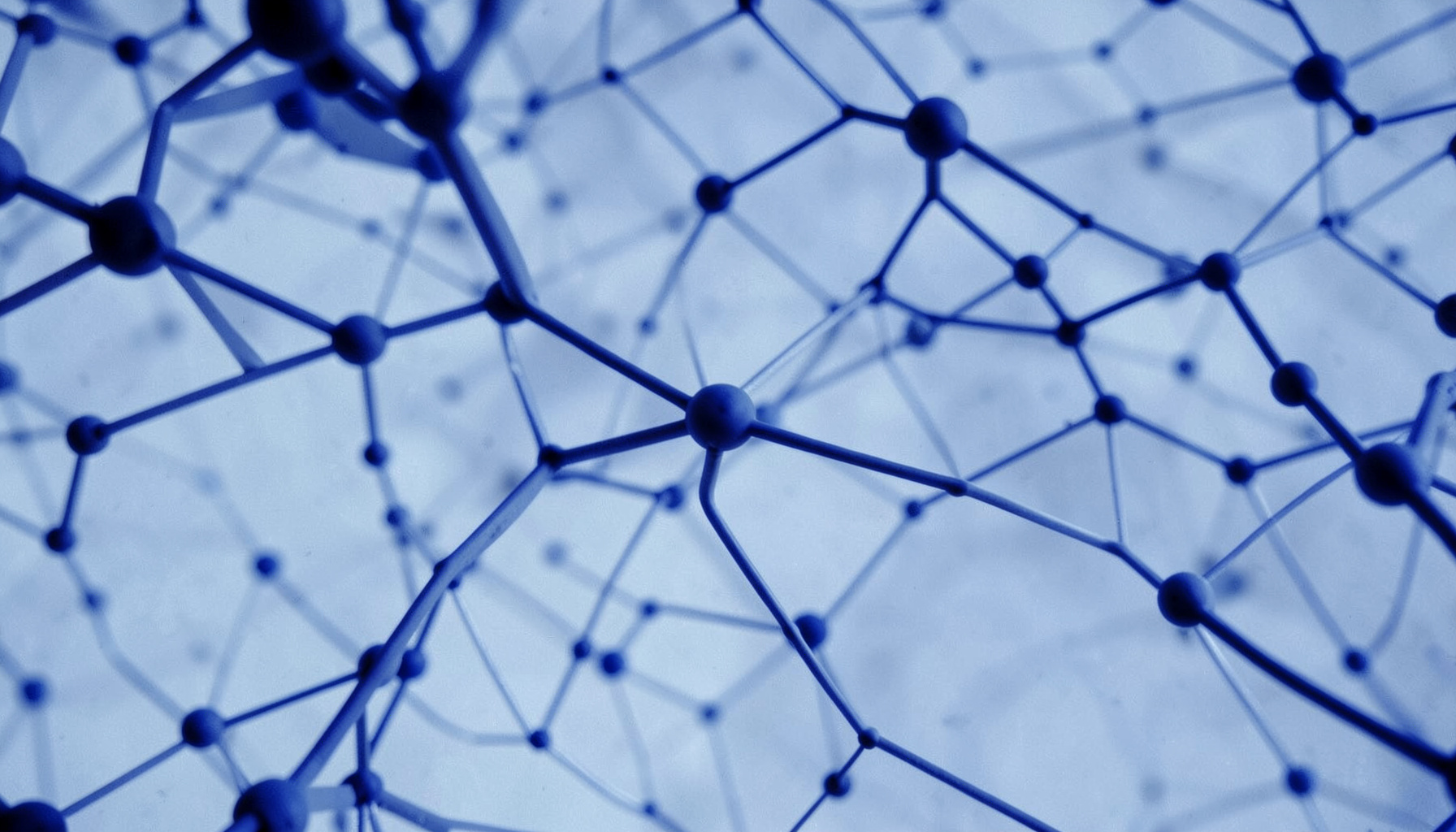 Duotone image of abstract network nodes and connections in indigo and pale blue